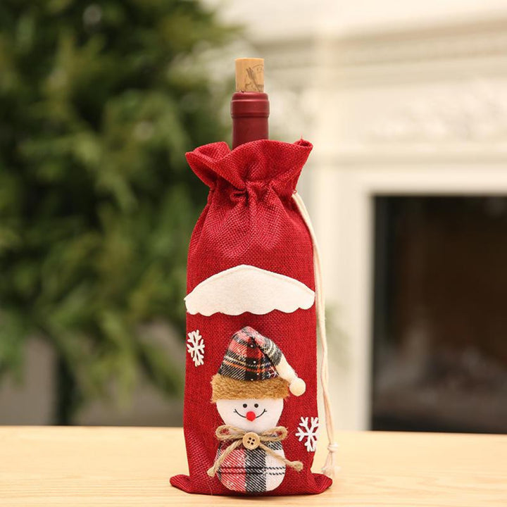 Bottle wrapped in a snowman linen red bag