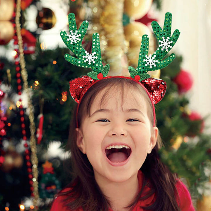 Child wearing a festive reindeer headband