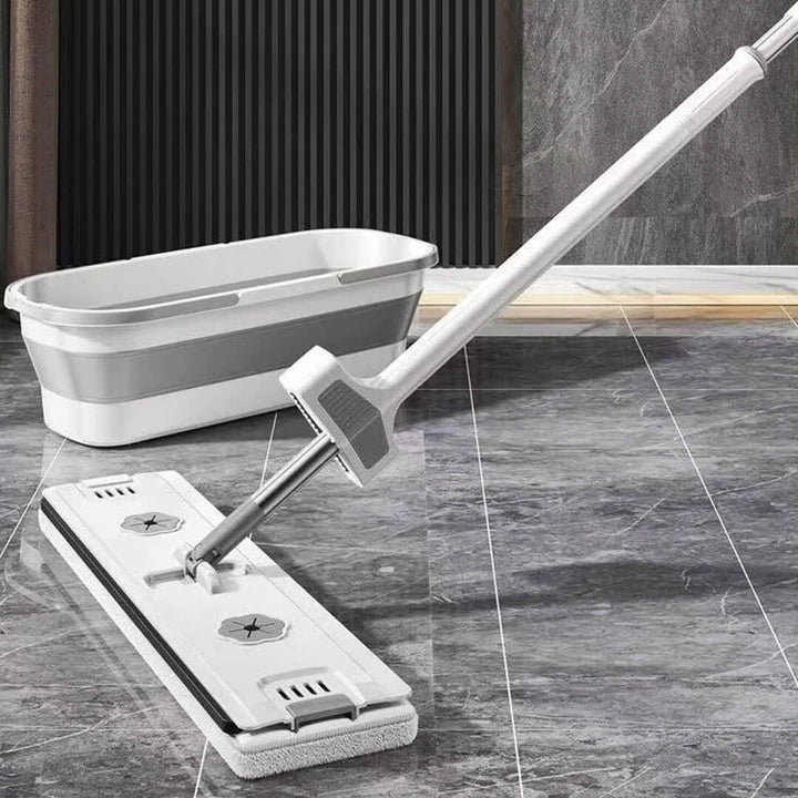 Microfiber mop cleaning tile floor with folding bucket nearby