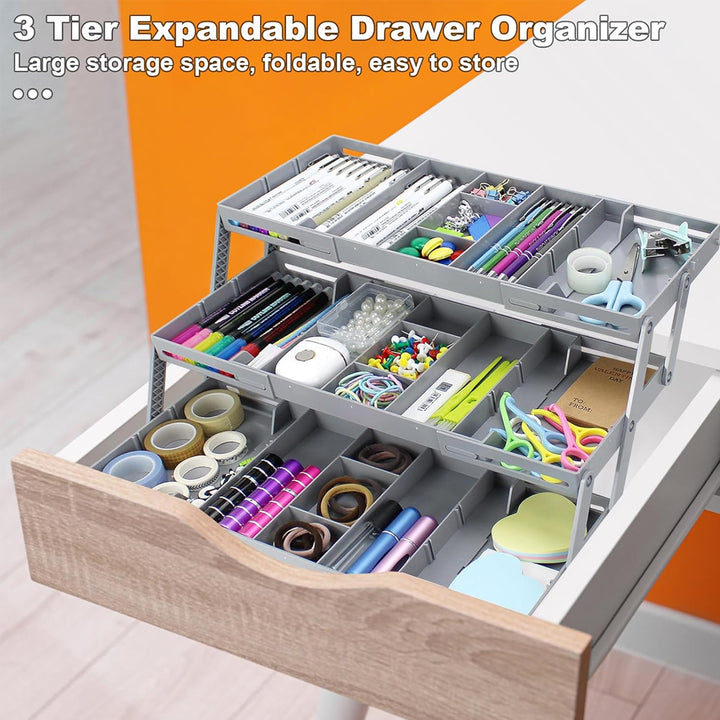 Three-tier expandable drawer organizer with stationery items inside an opened drawer