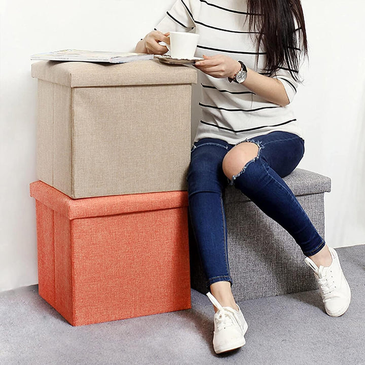 Foldable fabric storage stool with storage compartment in grey, peach, blue and navy colors