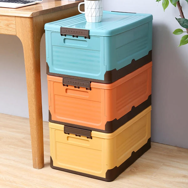 Foldable plastic storage boxes in orange, teal, and yellow colors with lids.