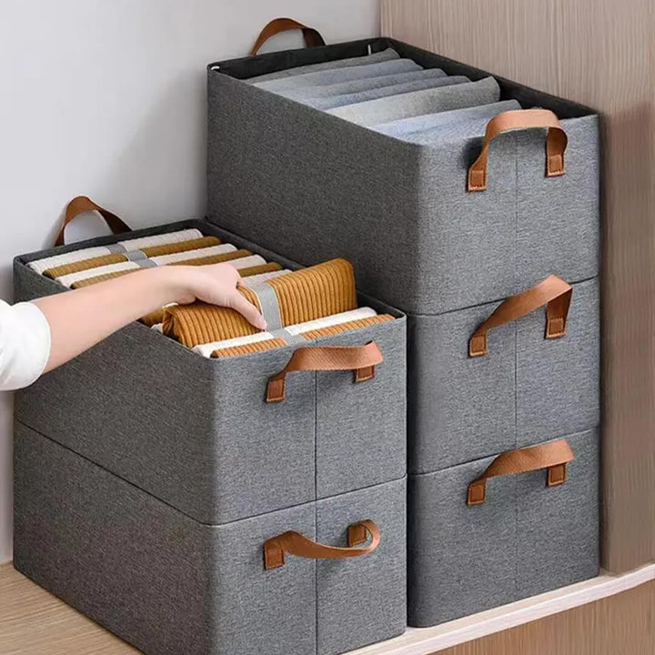 Stack of collapsible storage boxes for closet organization, grey color