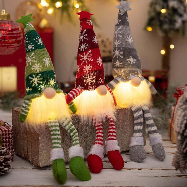 Three illuminated Christmas-themed gnomes
