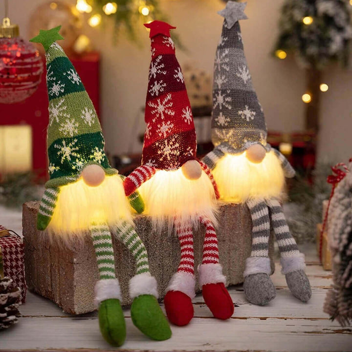 Three illuminated Christmas-themed gnomes