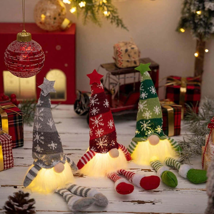 Glowing gnome decorations in red, green, and grey 