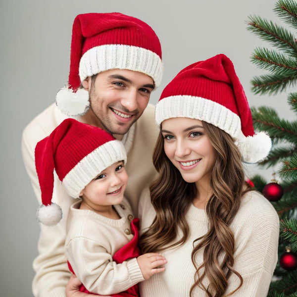 family wearing matching red knitted Santa hats