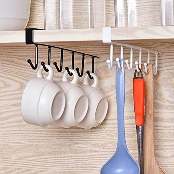 Kitchen cabinet organizer with hooks holding mugs and utensils.