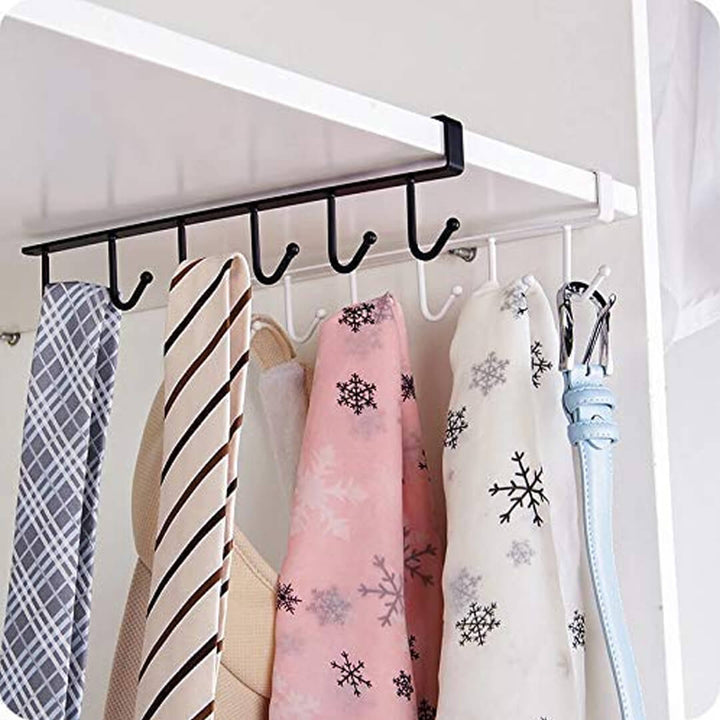 Clothing rack with multiple hooks holding various scarves and a belt.