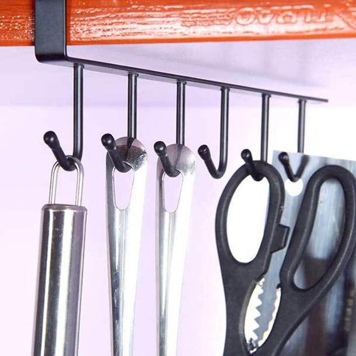 Wall-mounted hook organizer with various kitchen utensils 