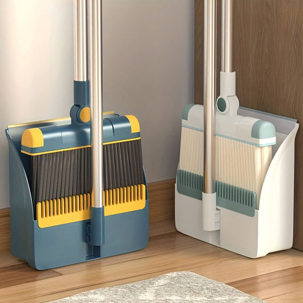 Two brooms with dustpan sets on a wooden floor.