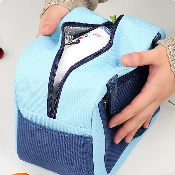 A light blue and navy insulated lunch bag with lunch and snack