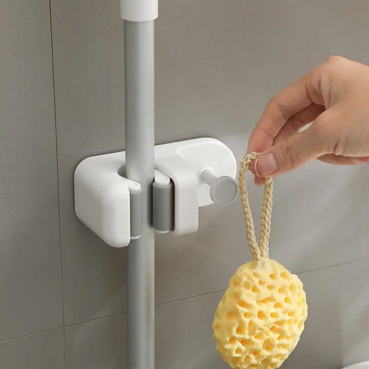 White waterproof mop rack holding a broom and sponge