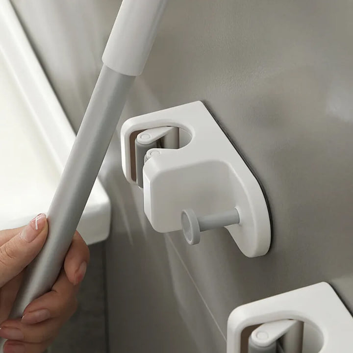 Space-saving adhesive wall hook for cleaning tools
