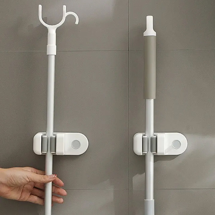 White plastic wall organizer for mop and sponge