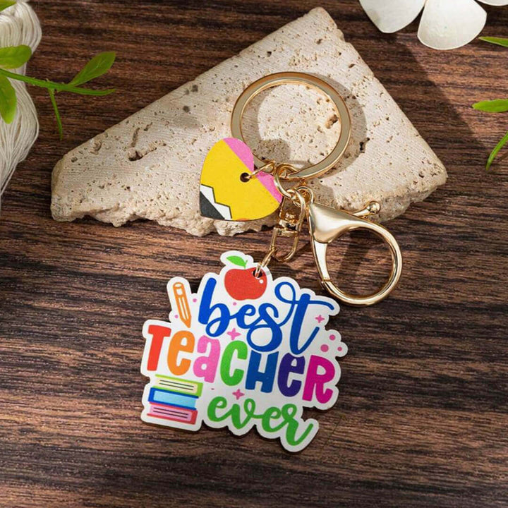 Wooden rainbow keychains for teachers, best teacher ever with books on the left.